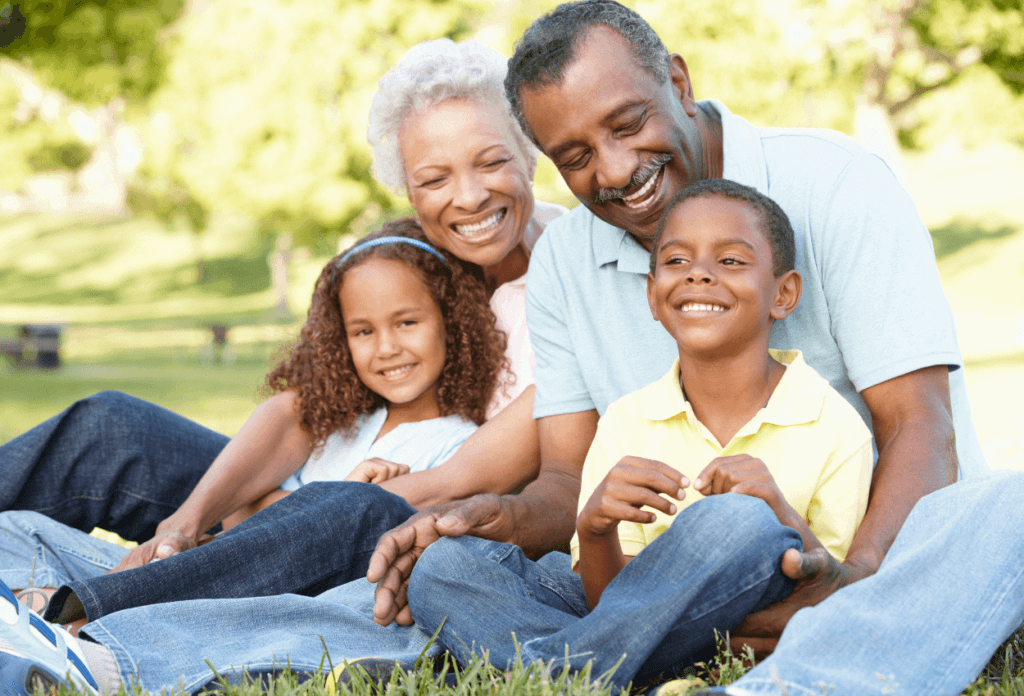 Grandparents sitting and hugging grandkids.