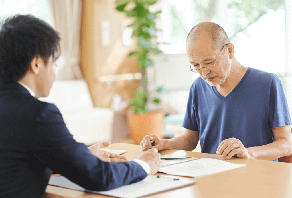 A business man going over paper work with a senior citizen