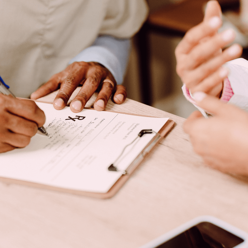A picture of a doctor writing a prescription.