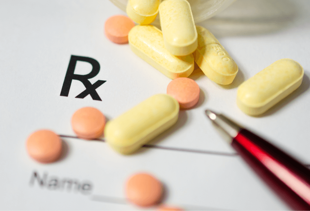 Examples of prescription pills lying on a doctor's prescription pad.