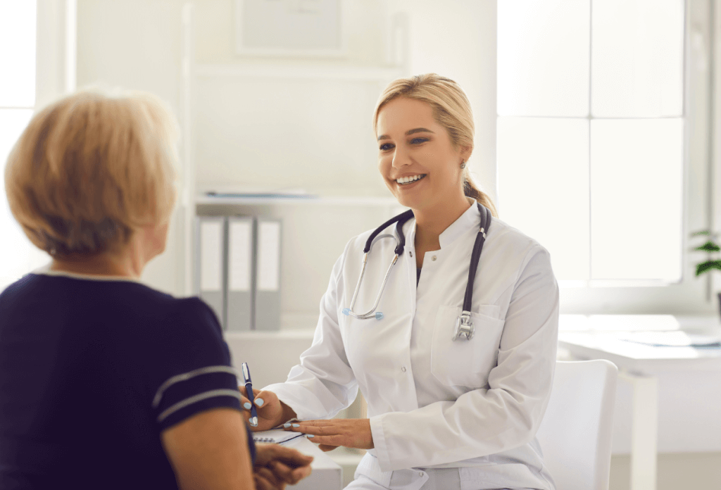 A female senior citizen is speaking with a female doctor.