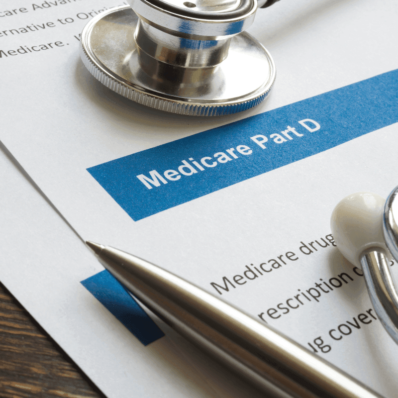 A picture of a Medicare Part D enrollment form with a pen and stethoscope on top.