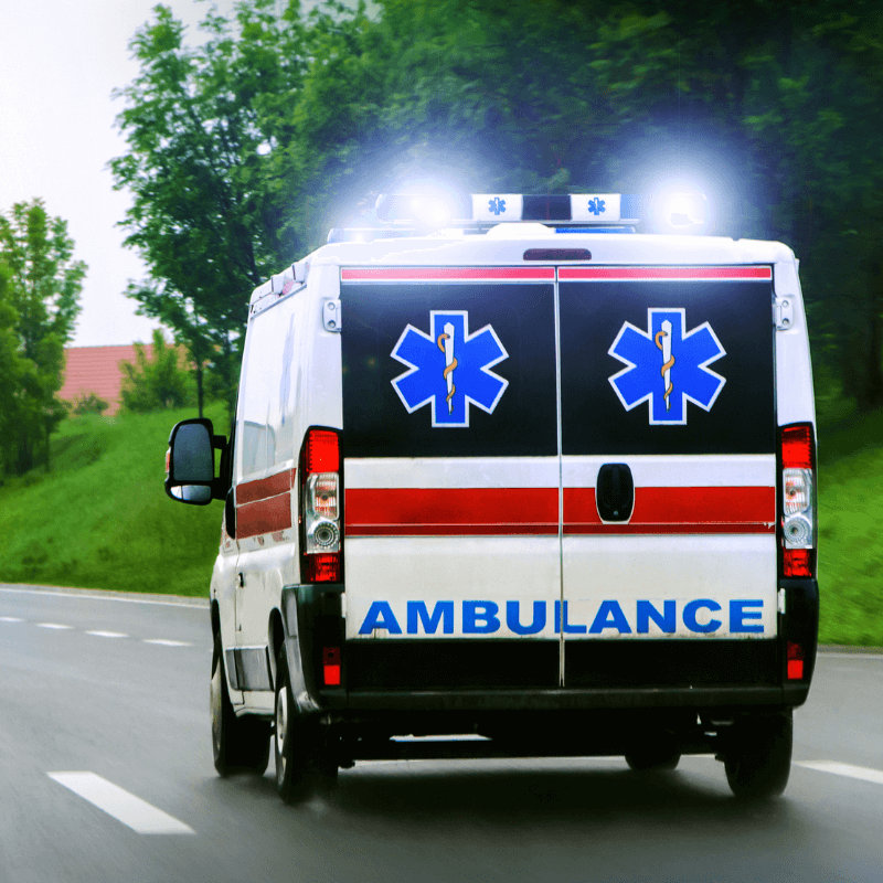 A picture of the back of an ambulance with their lights on.